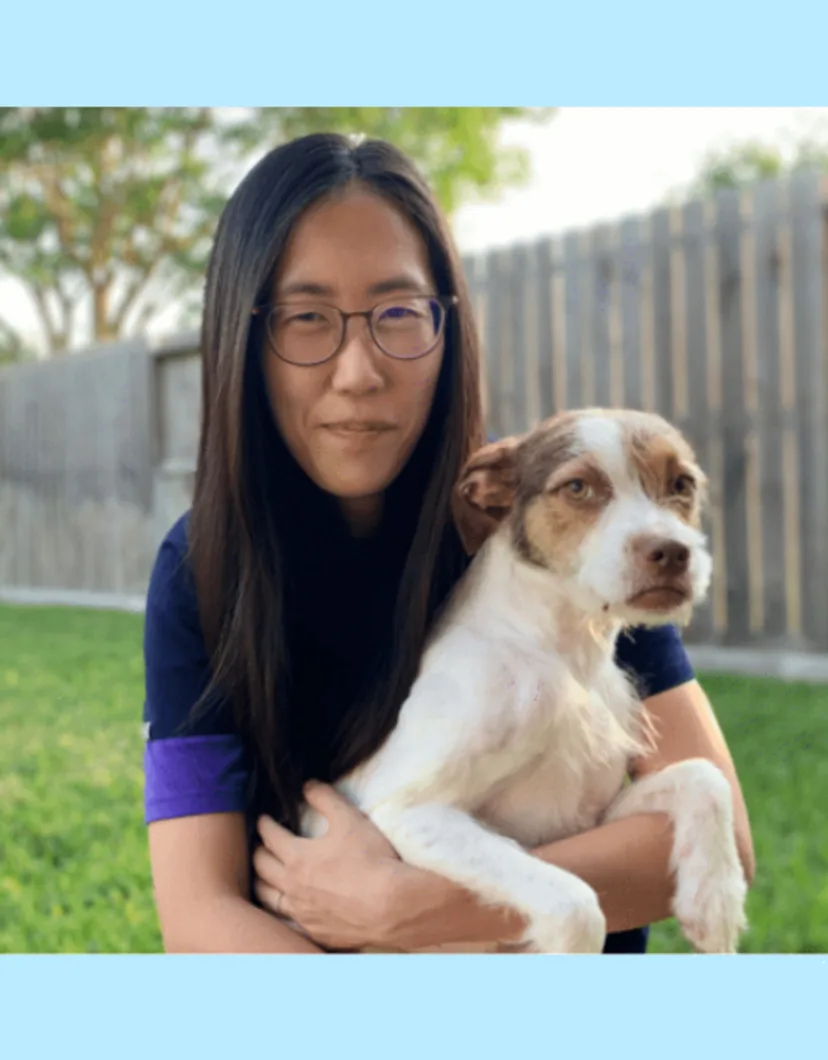 Dr. Lee holding her dog outside